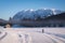 Woman running cross-country skiing with nice view to mountain Grimming