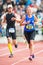 Woman running the final stretch at Stockholm Stadion in ASICS St