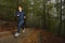 Woman running in forest area, training and exercising for trail run marathon endurance