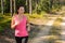 Woman running through forest outdoor training