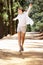 Woman running freely along country path