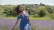 Woman running hand gently over lavender blossoms