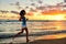 Woman running and jogging training beach sunrise