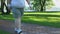 Woman running while man slowly walking in park, daily trainings for obese people