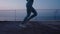 Woman running at nighttime. Young woman run sunrise seaside. Concept of health and lifestyle