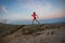 Woman running on rocks. Female cross country running in mountains.