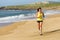 Woman running on sand beach