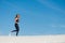 Woman running on sand in sport wear