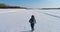 Woman running on a snow covered area. Aerial video.