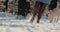 Woman running in the snow with her dog, having a good time on a walk in the winter forest