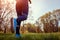 Woman running in spring forest. Close-up of sneakers. Helathy lifestyle concept. Active sportive people