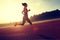 Woman running during sunny morning on stadium track