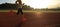 Woman running during sunny morning on stadium track