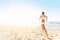 Woman Running on Sunny Sea Beach, Rear Back View, Jogging Girl in White Sexy Sport Clothes