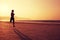 Woman running on sunrise sandy beach