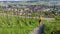 Woman running in the Swiss vineyards