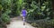 Woman running on trail at `Bosque da Freguesia`, Freguesia Forest Public Park, Rio