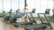 Woman running on treadmill. Exercise bikes and treadmills in sports center. 3D illustration