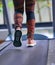 Woman running on treadmill in fitness gym with sport shoes ,back lower feet view,motion blur