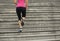 Woman running up on stone stairs