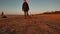 Woman running, walking, playing and having fun with her doggy at sunset on a beach near Baltic sea in spring. Colorful