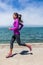 Woman running on waterfront harbour San Francisco