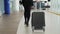 Woman runs at the airport terminal, businesswoman business woman luggage baggage suitcase shopping mall, travel concept