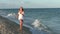 Woman runs along the beach.