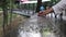 A woman runs her hand along the wet wooden handrails while walking in the park after the rain. Close-up of a Caucasian woman touch