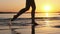 Woman Runs on Shallow Water at Golden Sunset along the Beach. Slow Motion 240fps