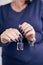 Woman`s beautiful hand with blue manicure with bottles of nail polish