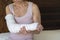 Woman`s broken arm inside a white bandage wrap