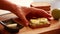 Woman\\\'s CloseUp Hands Preparing Avocado Toast with Boiled Egg