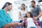 The woman`s doctor has finished treating the girl. Next to the girl, her parents.