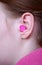 Woman\'s ear with earplug