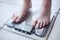 Woman\'s feet on bathroom scale. Diet concept