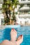 Woman`s feet relaxed in swimming pool