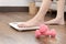 Woman`s feet stepping on electronic scales