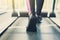 Woman`s feet on treadmill in fitness club, healthy lifestyle