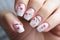 Woman\\\'s fingernails with beautiful seasonal spring cherry tree flower nail art design