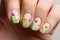 Woman\\\'s fingernails with beautiful spring themed nail polish with tulip flower art deisgn