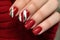 Woman\\\'s fingernails with nail polish with seasonal Christmas themed design