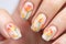 Woman\\\'s fingernails with orange tulip spring flower nail art design