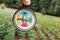 Woman`s fingers holding a colorful compass at the forest.