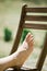 Woman`s foot on wooden chair outdoor