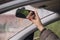 Woman`s hand adjusts the rearview mirror in the car close up