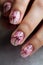 Woman\\\'s hand with beautiful nail design. Manicure with beige lacquer and flowers