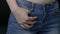 Woman`s hand in blue jeans pocket