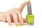 Woman\'s hand with a bottle of green nail polish