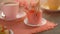 Woman\'s hand breaks a piece off strawberry dessert